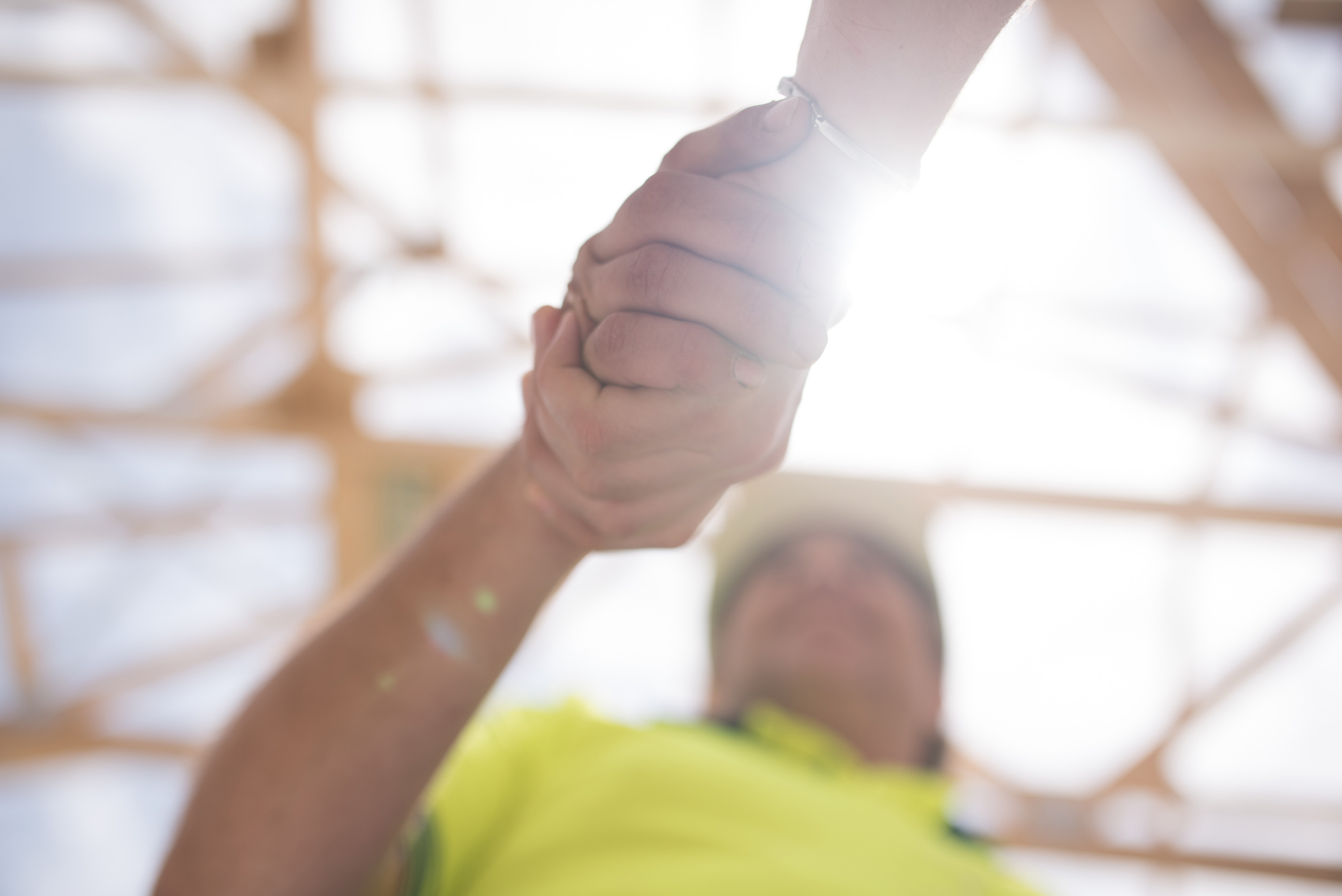 Close up of construction worker giving a handshake to manager of the objectt